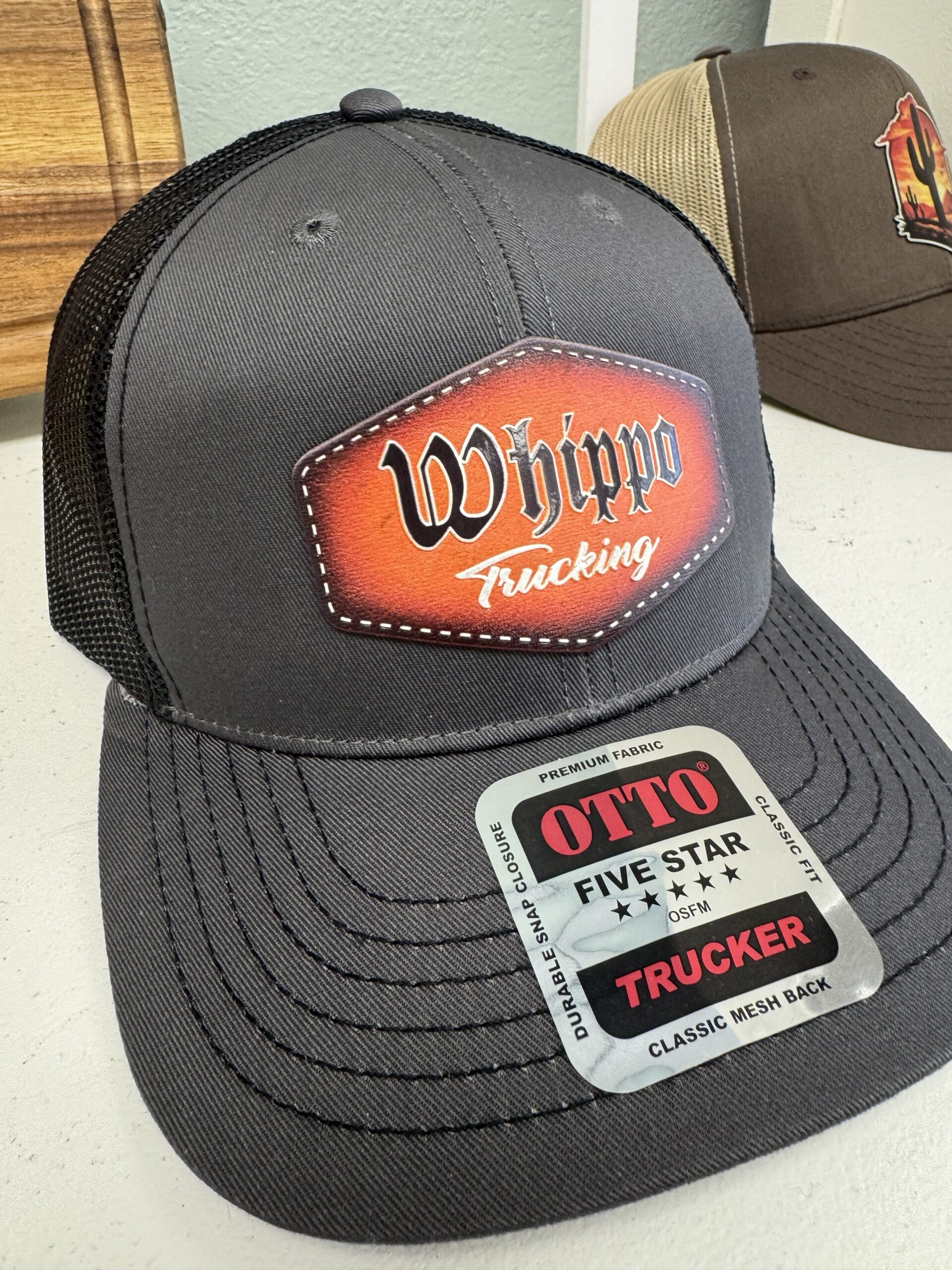 Richardson 112 trucker cap with an engraved Whippo Trucking leatherette patch