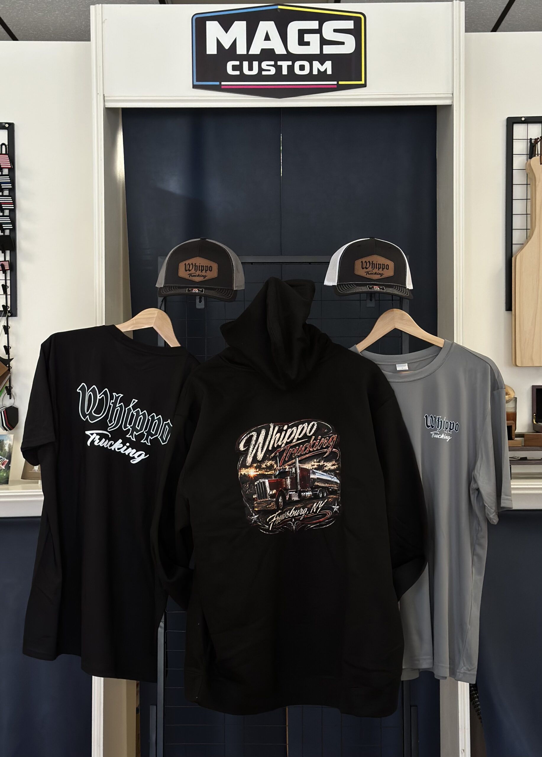 Custom apparel order for Whippo Trucking with DTF shirts, V.I.T. hoodie and Richardson patch hats