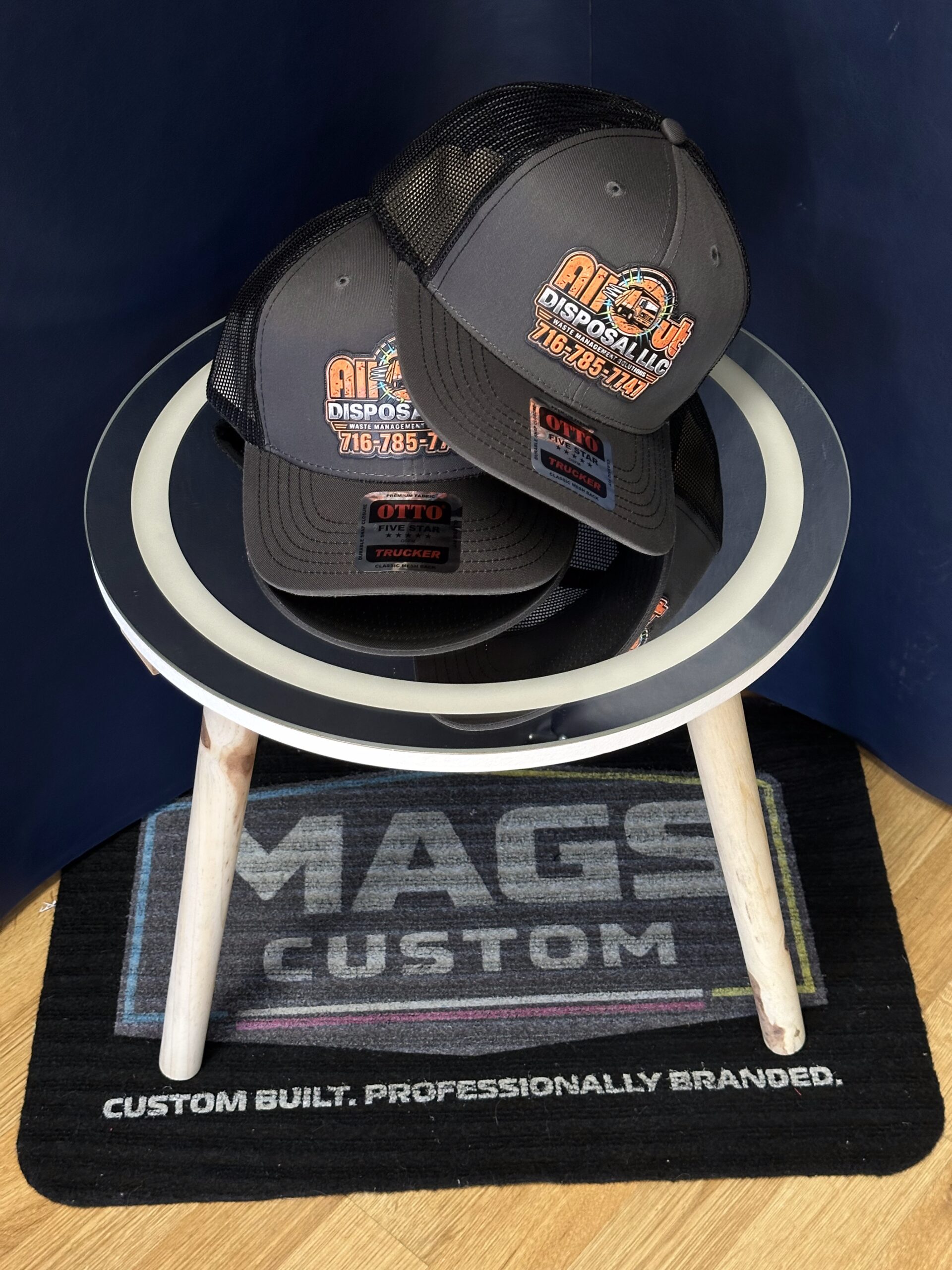 UV printed texture patches for All Out Disposal staged with branded hats