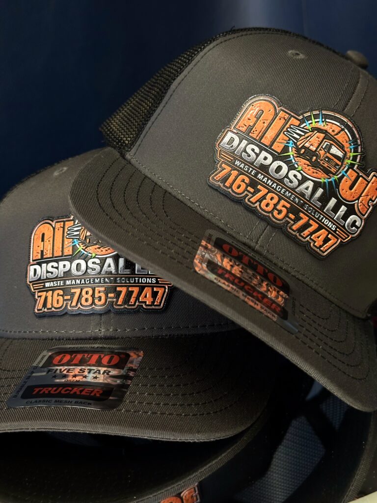 Close-up of raised UV printed lettering on an All Out Disposal leatherette patch