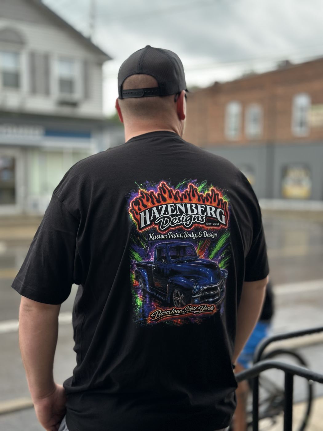 Black t-shirt with Hazenberg Designs full back DTF print showing custom painted truck and flames, Barcelona NY