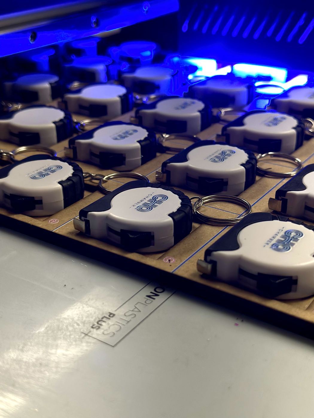 700 custom tape measure keychains for Chautauqua County Chamber of Commerce being UV-printed for Small Business Week 2026
