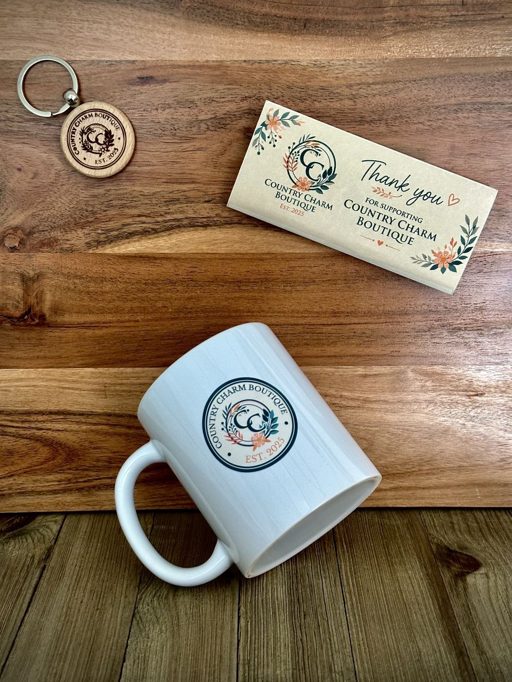Laser-engraved wood keychain, UV-printed candy bar wrapper, and UV-printed ceramic mug for Country Charm Boutique in Frewsburg NY