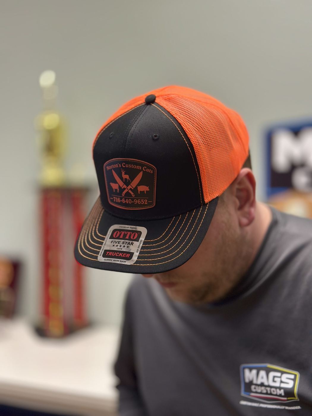 Custom leather patch structured trucker hat on model by Mags Custom, Frewsburg NY